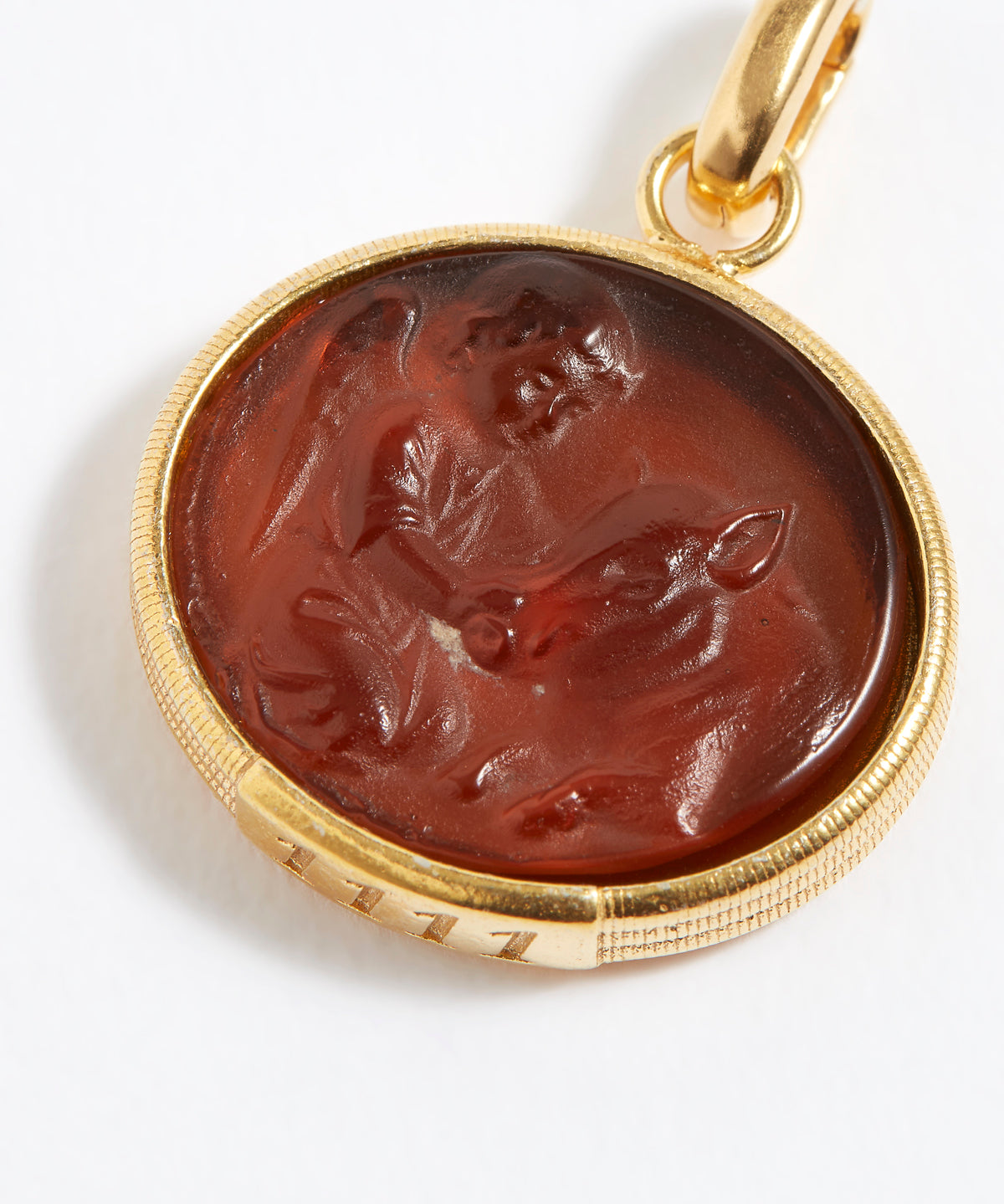 Gold pendant with a topaz stone featuring an engraved design angel numbers 1111 on a white background