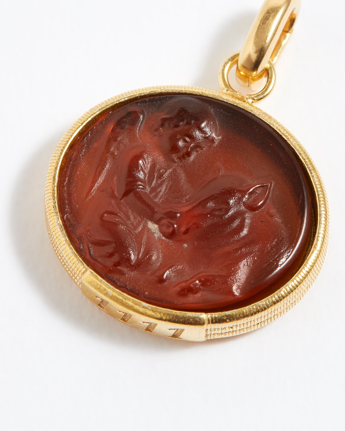 Gold pendant with a topaz stone featuring an engraved design angel numbers 1111 on a white background