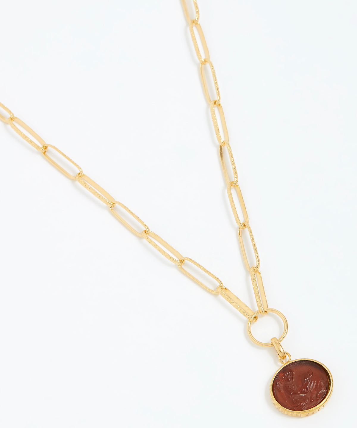Gold necklace with a round topaz pendant on a white background