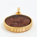 Gold pendant with a topaz stone and engraved angel numbers 1111 on a white background