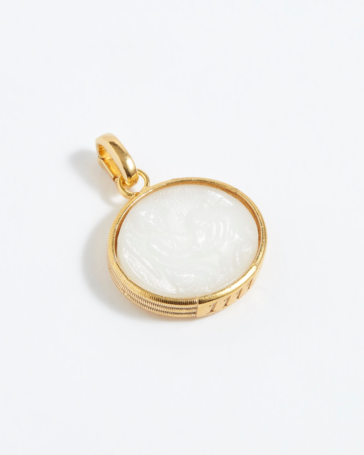 Gold pendant with a white stone on a light gray background