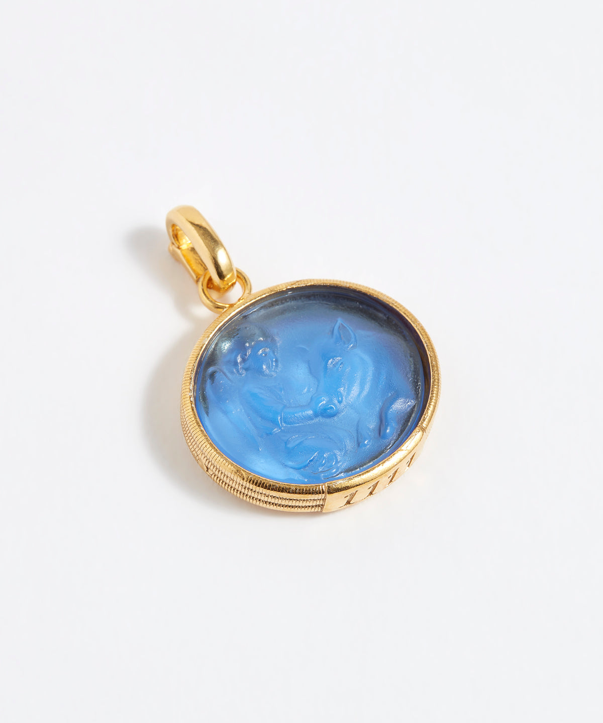 Gold pendant with blue stone on a white background