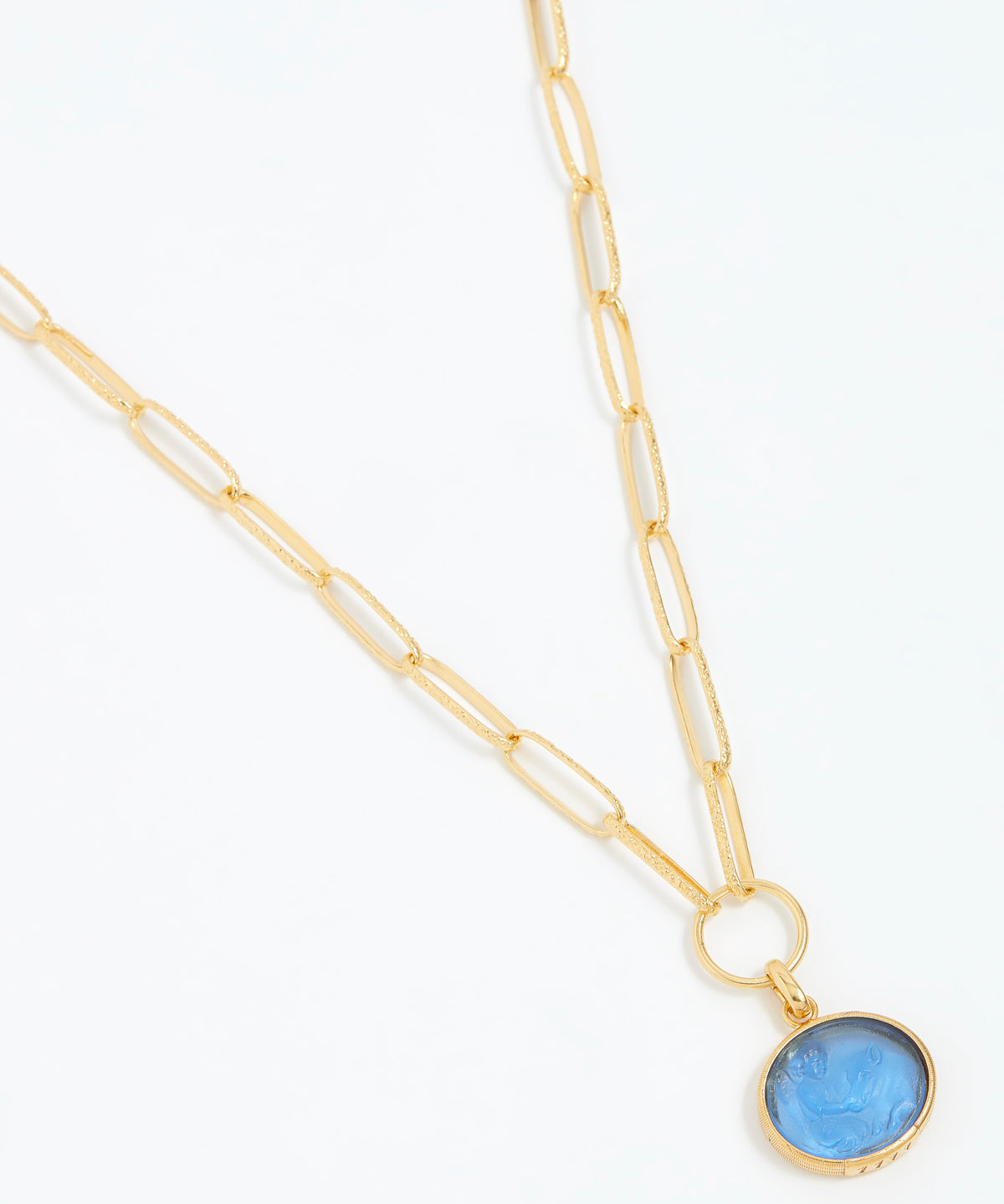 Gold necklace with a blue pendant on a white background