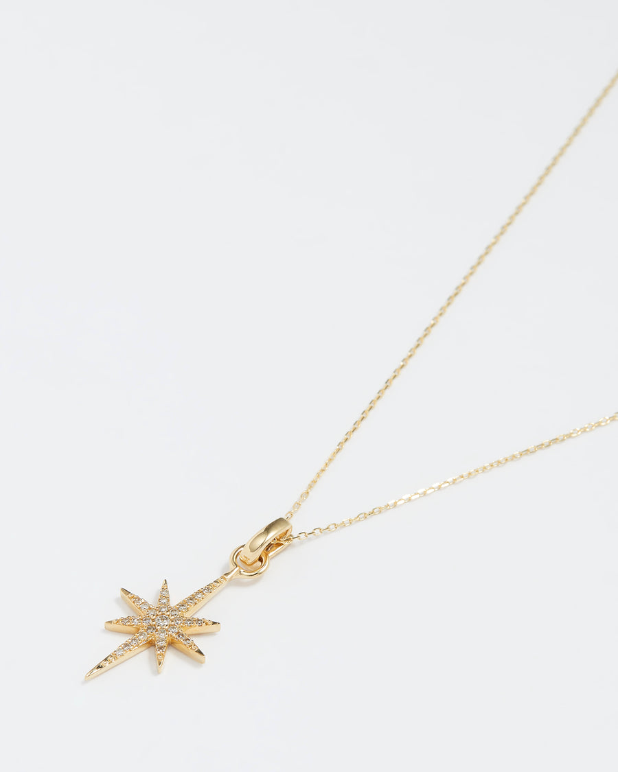 gold and diamond shining star charm, product shot on necklace chain