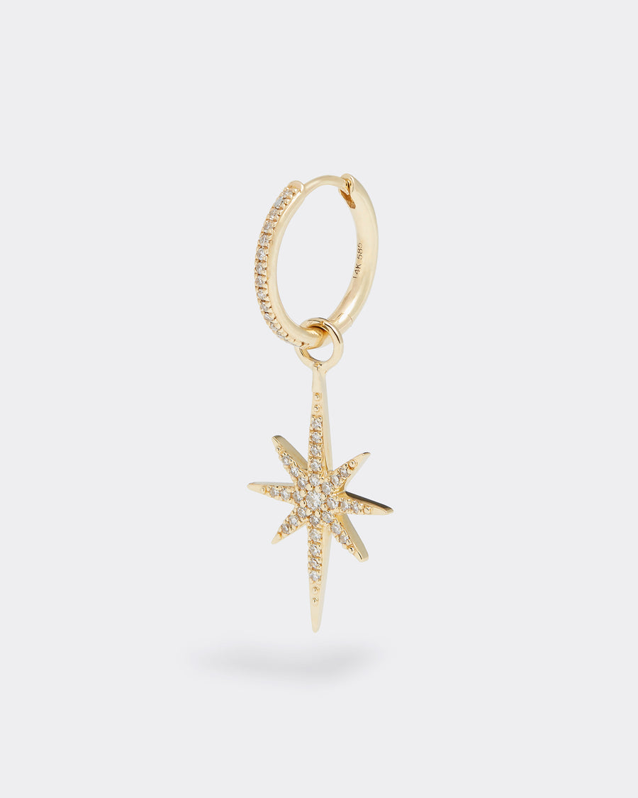 gold and diamond shining star charm, product shot on earring hoop