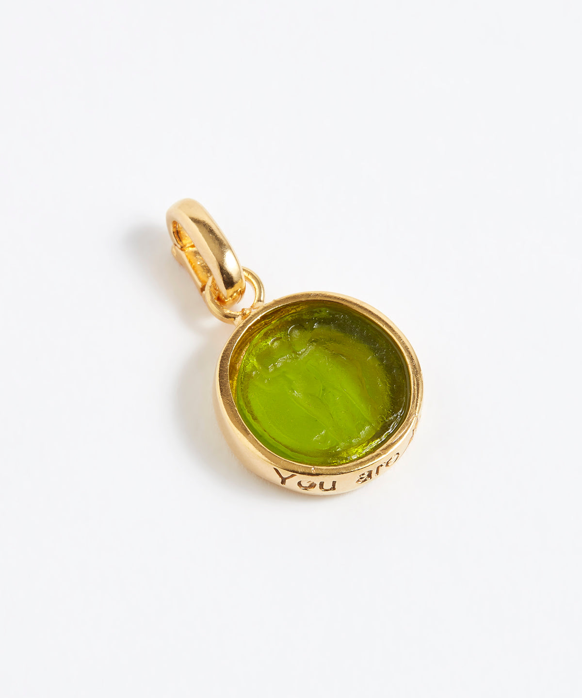 Gold pendant with a green gemstone on a white background