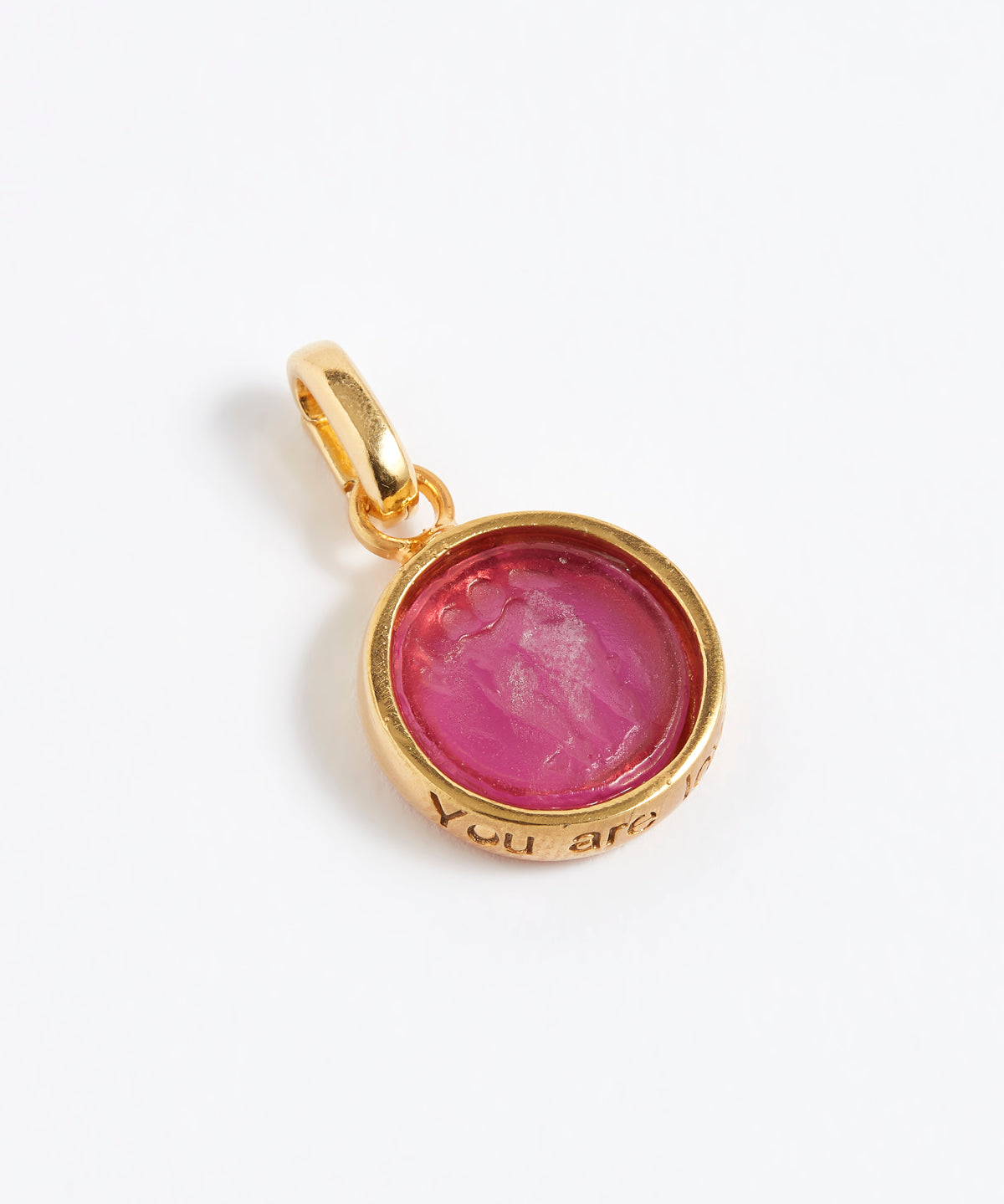 Gold pendant with a pink stone on a white background