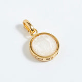 Gold pendant with a white stone on a white background