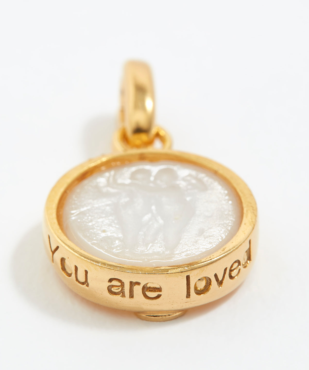 Gold pendant with engraved text 'You are loved' on a white background