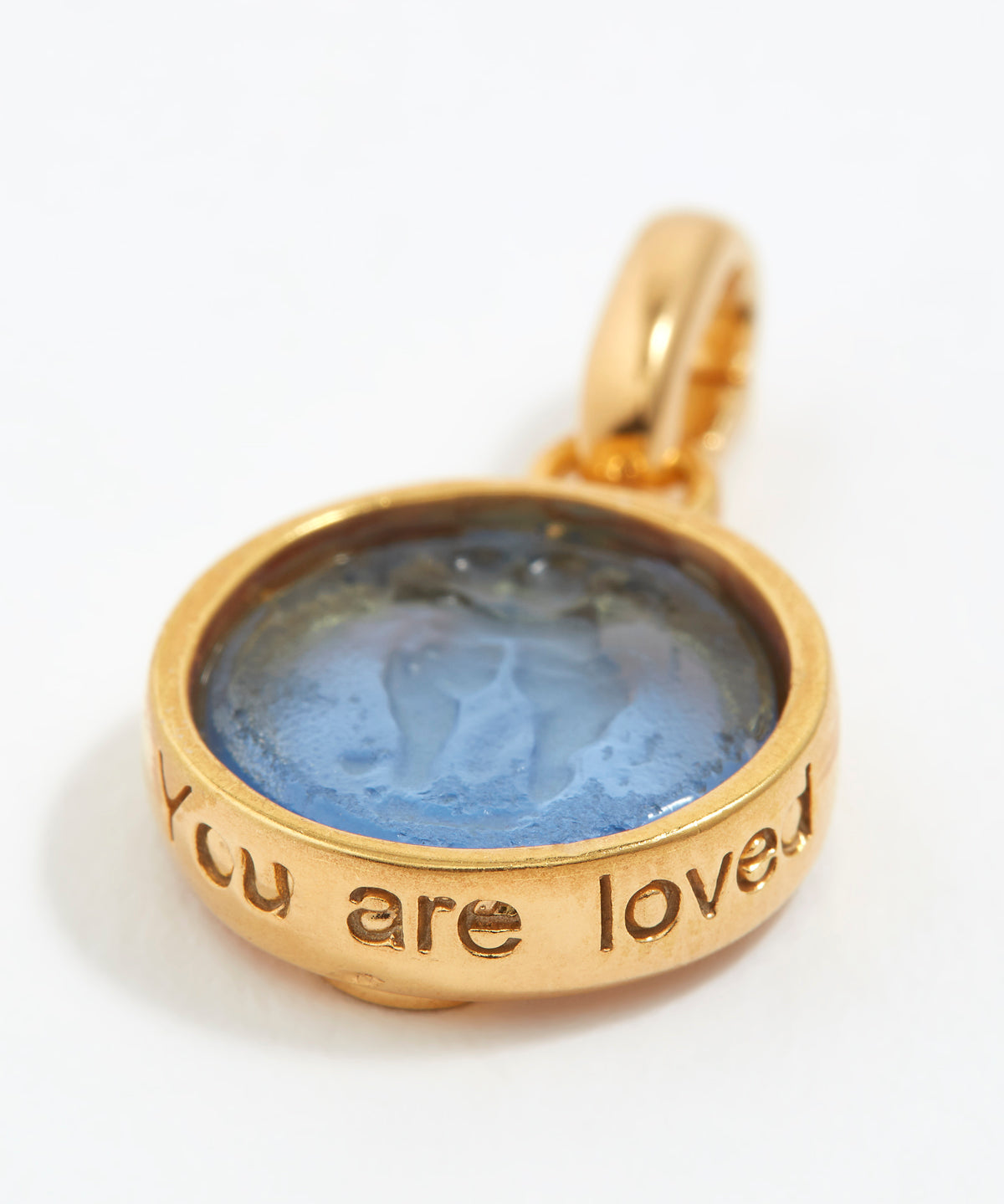 Gold pendant with blue stone and 'You are loved' engraving on a white background