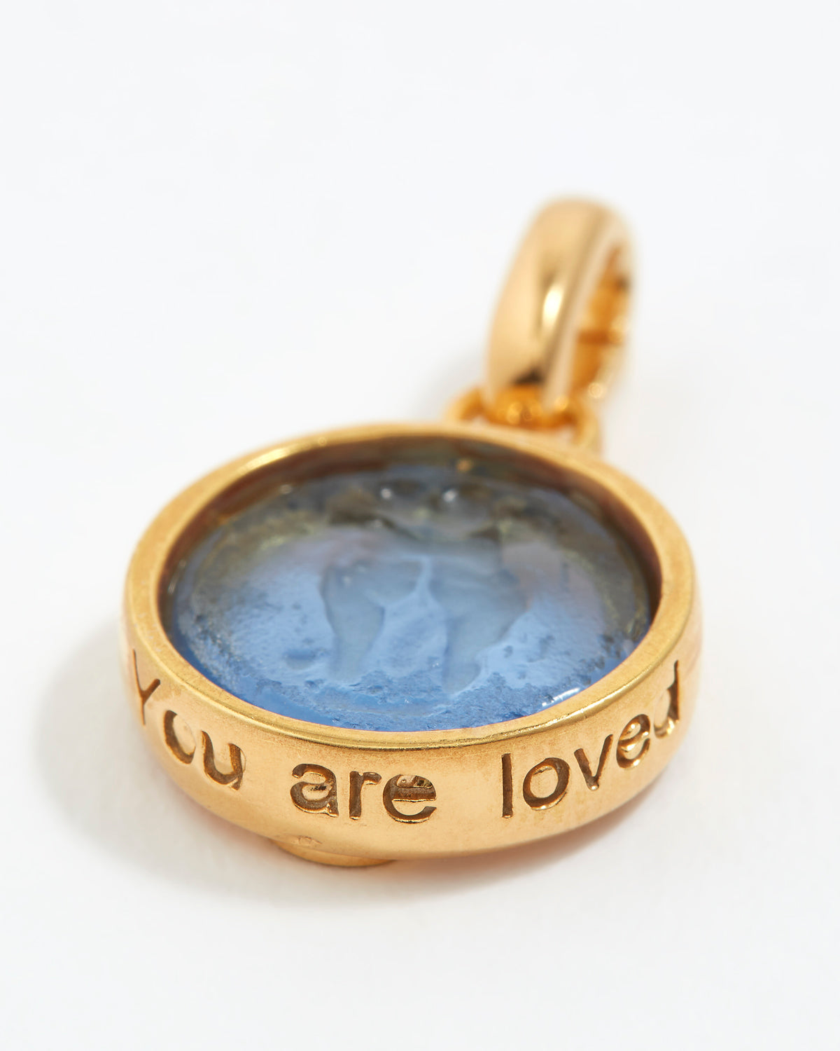 Gold pendant with blue stone and 'You are loved' engraving on a white background