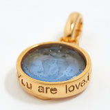 Gold pendant with blue stone and 'You are loved' engraving on a white background