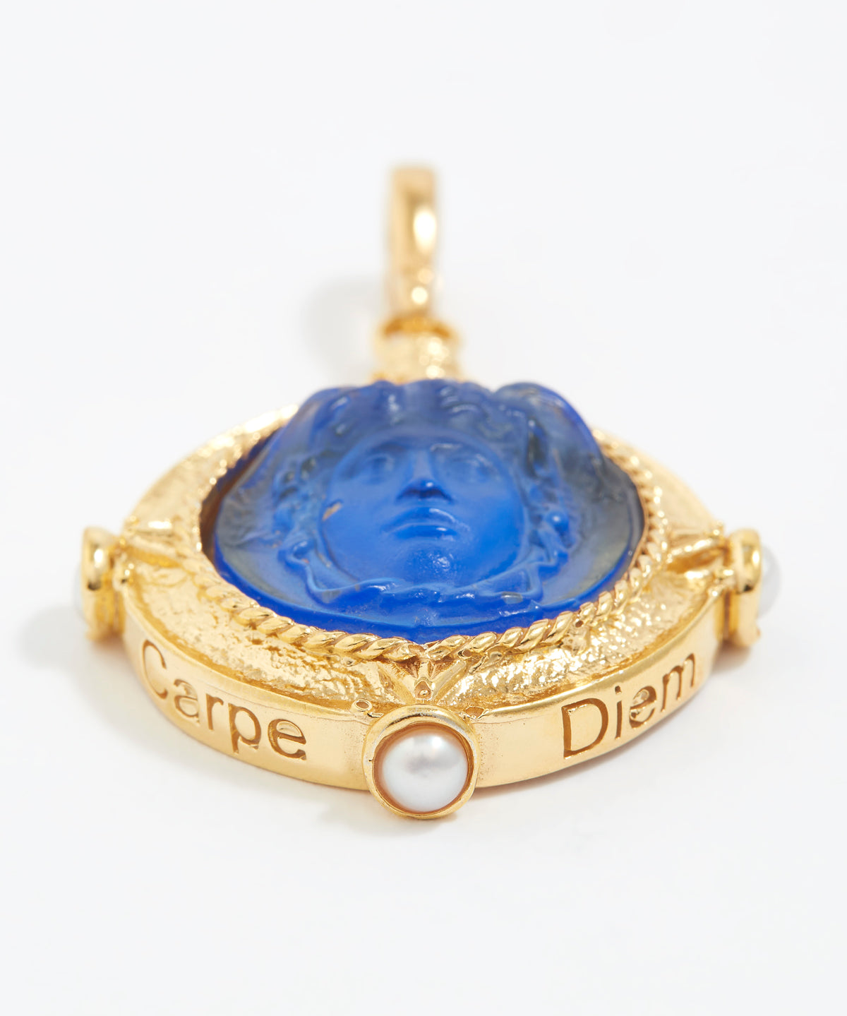 Gold pendant with blue center and 'Carpe Diem' text on a white background