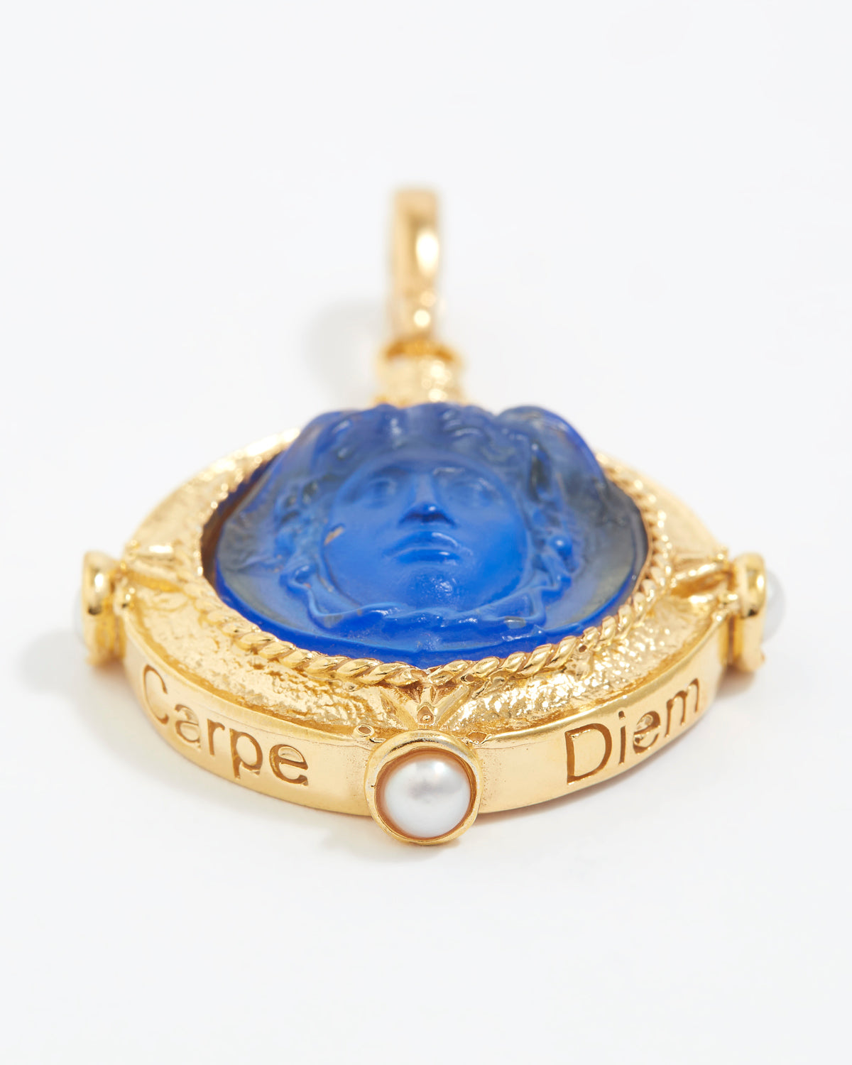 Gold pendant with blue center and 'Carpe Diem' text on a white background
