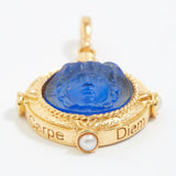 Gold pendant with blue center and 'Carpe Diem' text on a white background