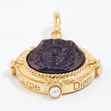 Gold pendant with purple stone engraved with wording  "Carpe Diem" and pearl on a white background