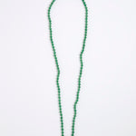 A green agate beaded necklace made of small, round, polished beads with a tiny gold spacer accent, displayed on a white background.