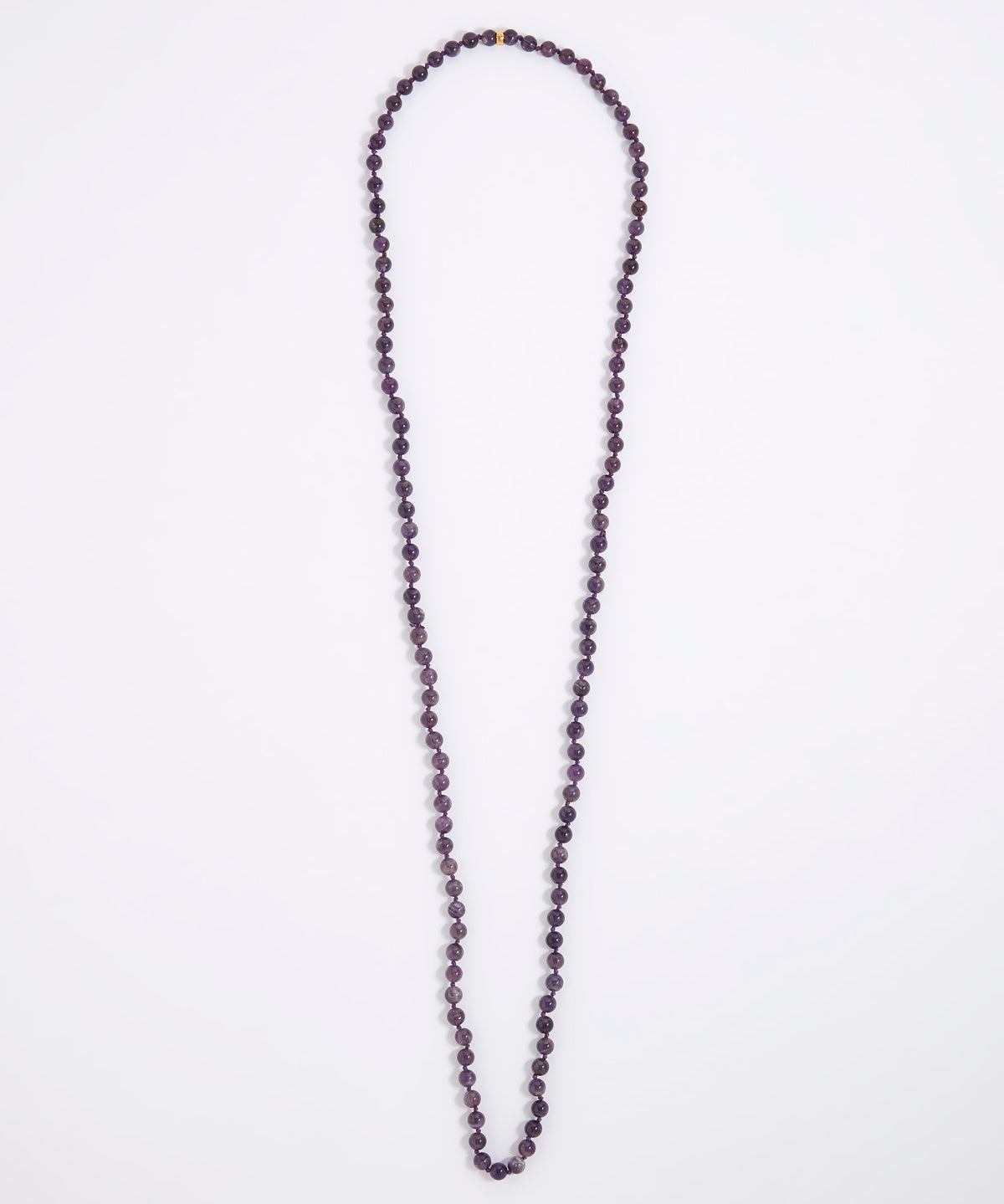 A long beaded necklace made of small dark purple faceted beads, laid flat on a plain white background.
