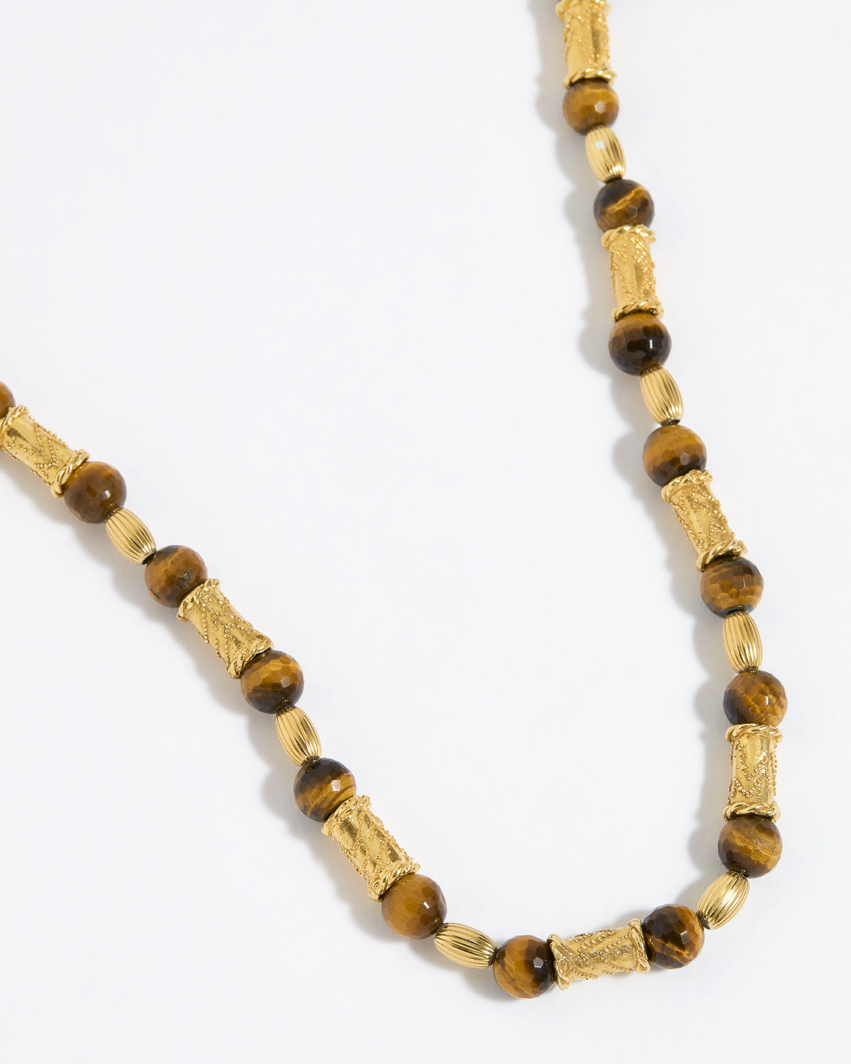 Beaded necklace with gold and tigers eye beads on white background