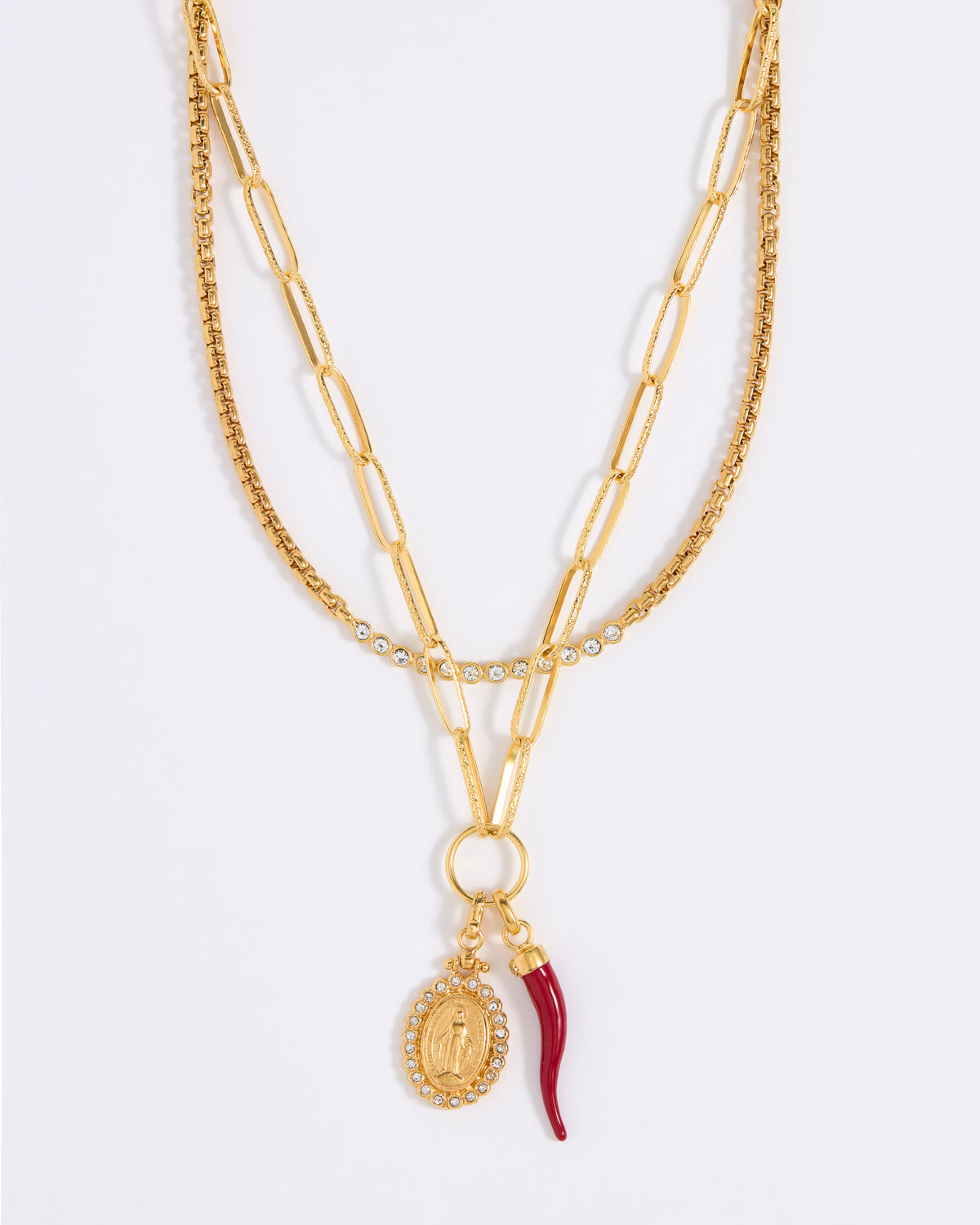 Gold chain necklace set with red cornucopia and crystal pendant charms on a white background