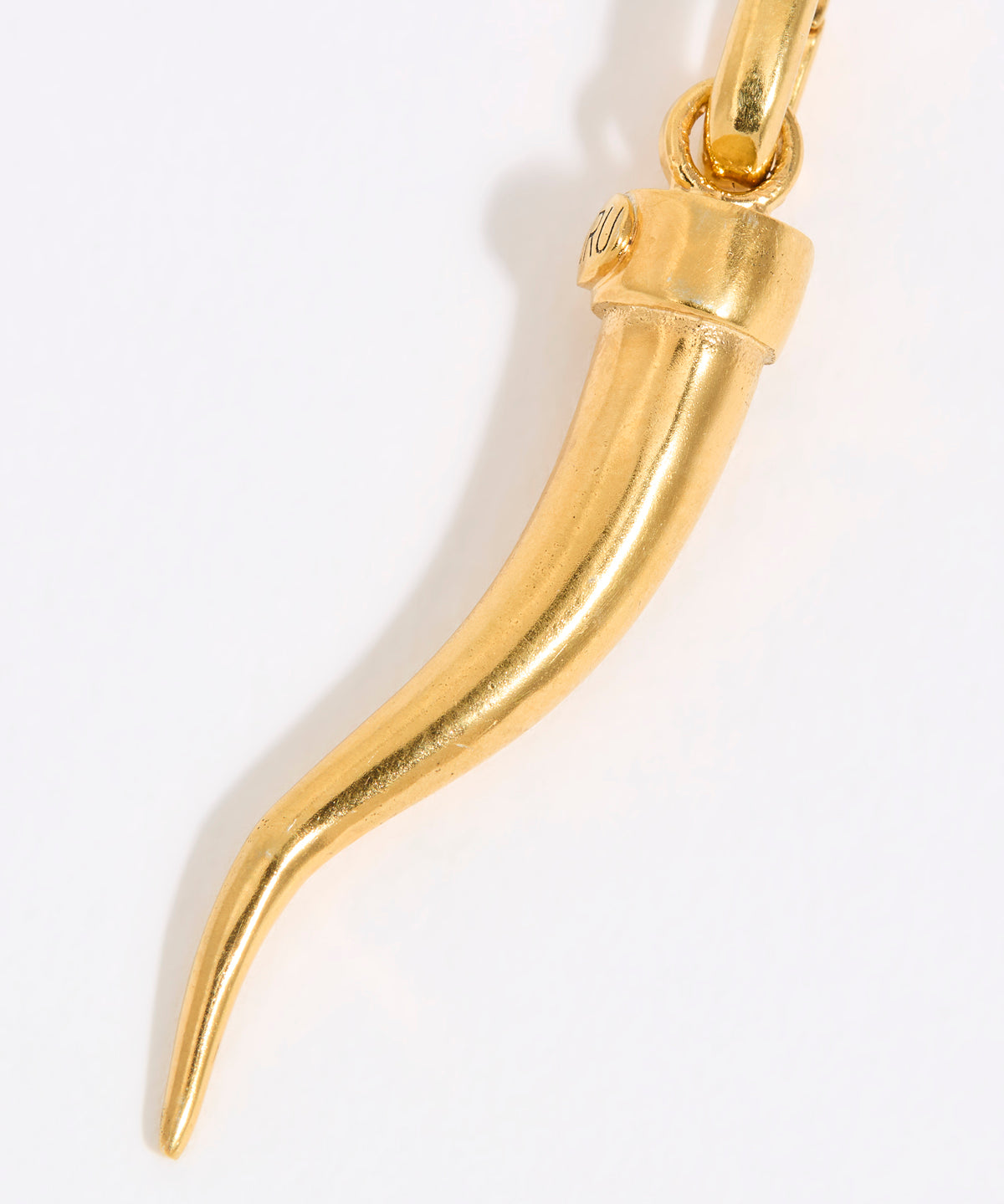 Gold horn-shaped cornicello pendant on a white background