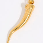 Gold horn-shaped cornicello pendant on a white background