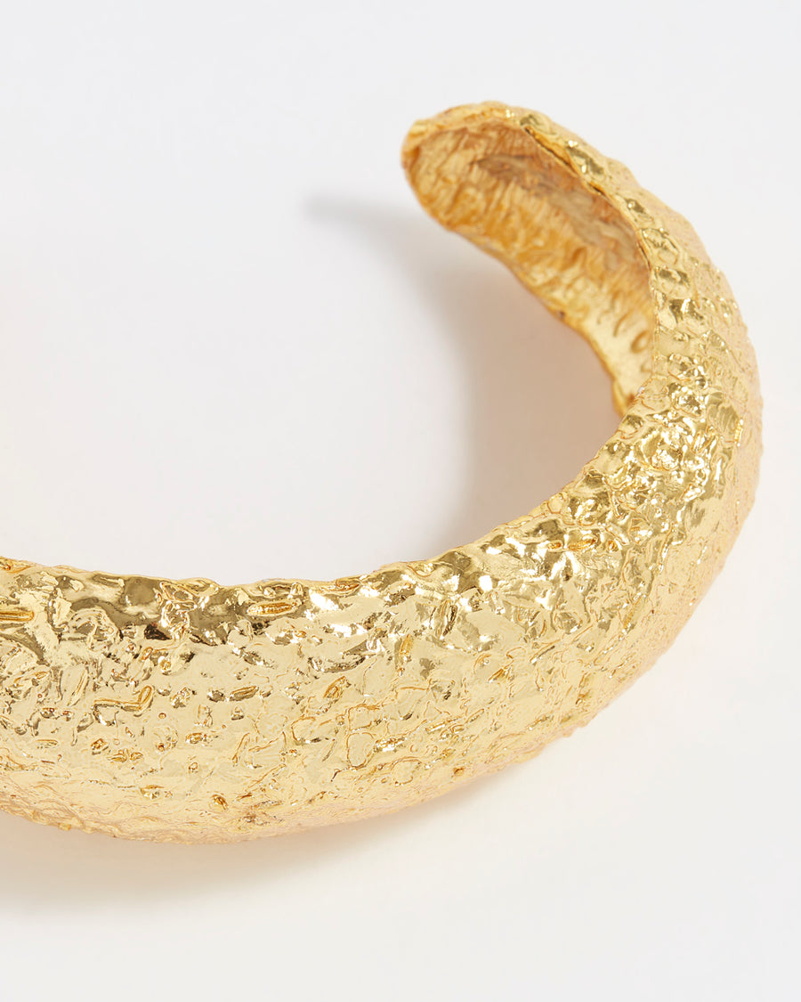 close up of gold plated silver thick textured cuff bracelet
