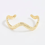 front image of textured curved gold bracelet cuff