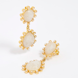 Close up product shot of gold earrings with teardrop shaped moonstones and small pearls on  white background