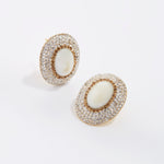  large pearl stud earrings surrounded by crystals
