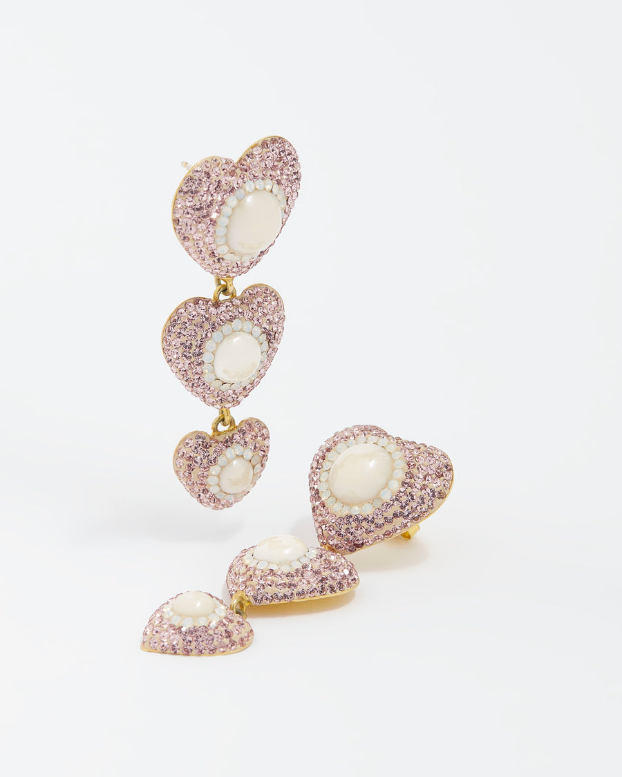 pink triple heart drop earrings with centre pearls on a white background 