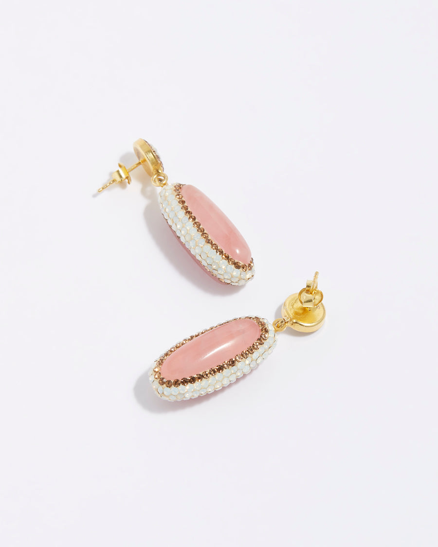 product shot of pink rose quarts long oval earrings surrounded by white crystals