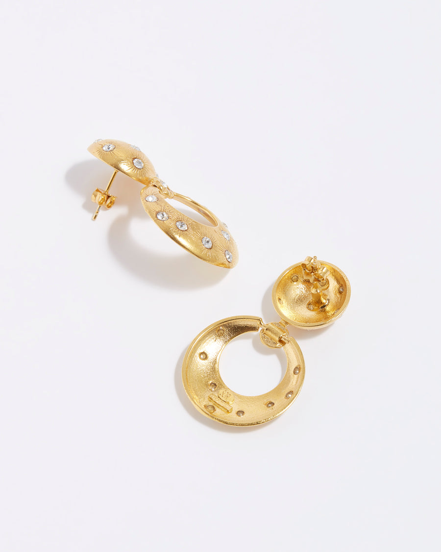 product shot of chunky gold door knocker style earrings with clear crystal stars etched into the gold plated silver