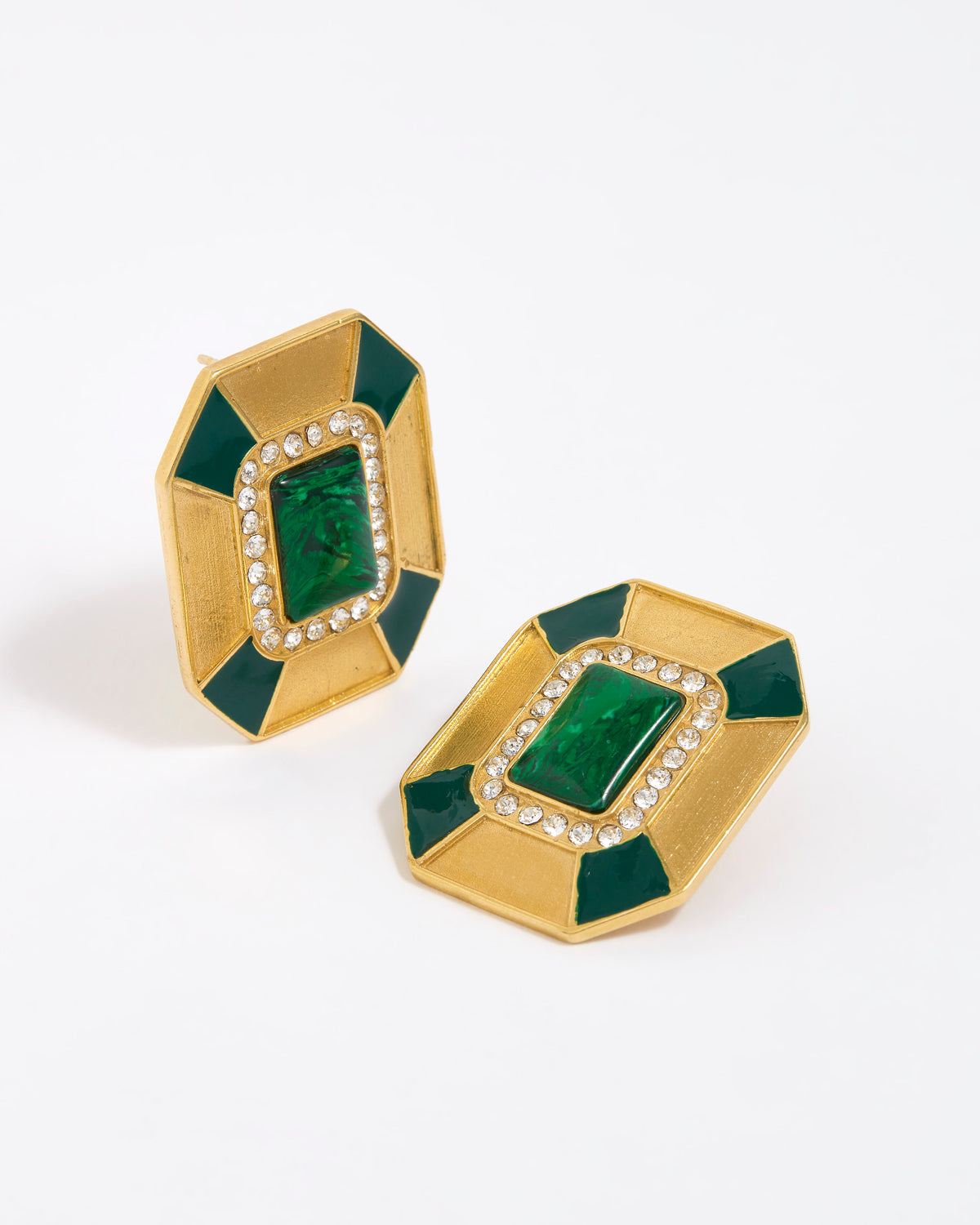 Close up image shot of statement gold and green malachite earrings with clear crystal embellished on a white background