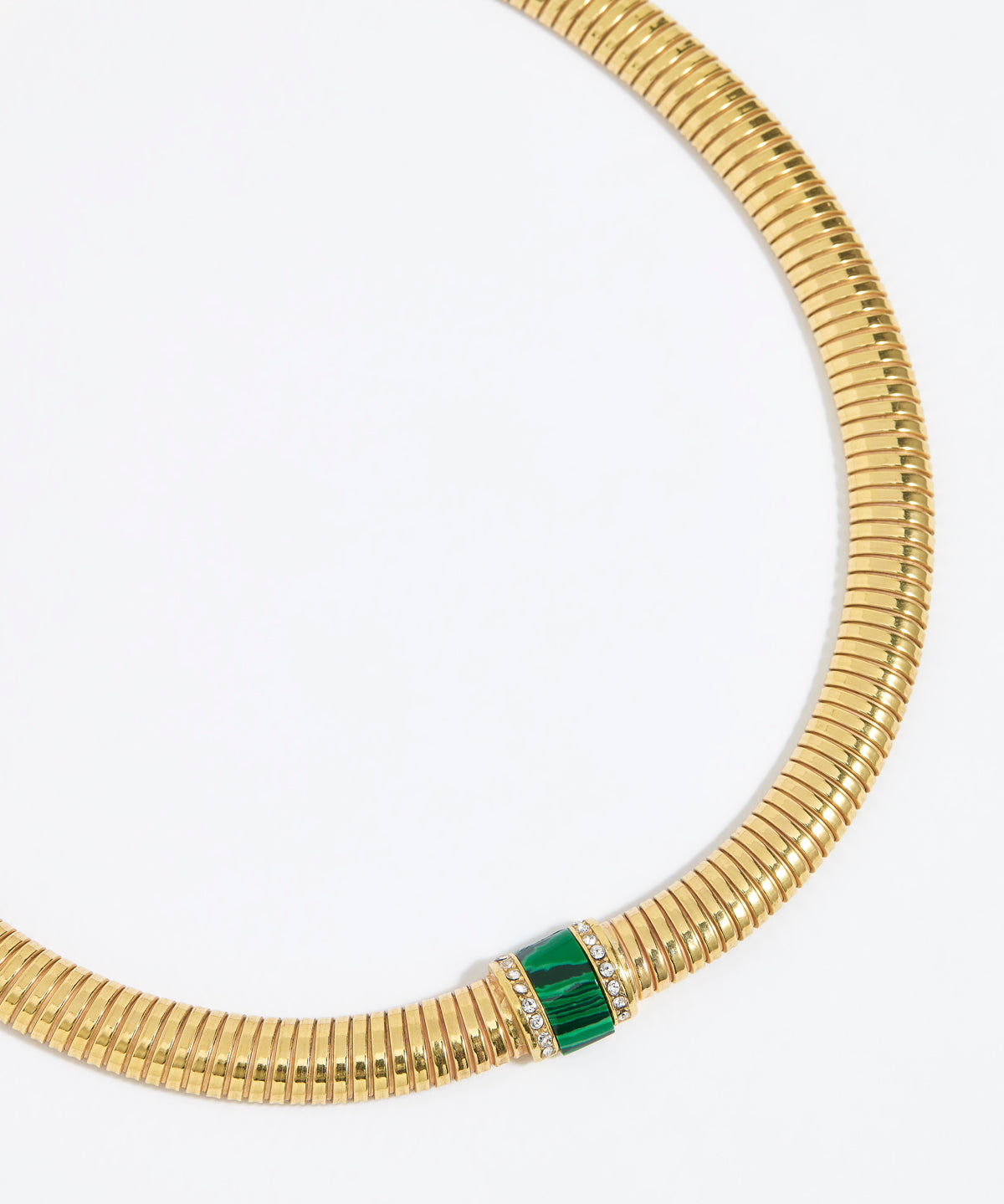 Gold chunky necklace with a green malachite gemstone embellished with clear crystals on a white background