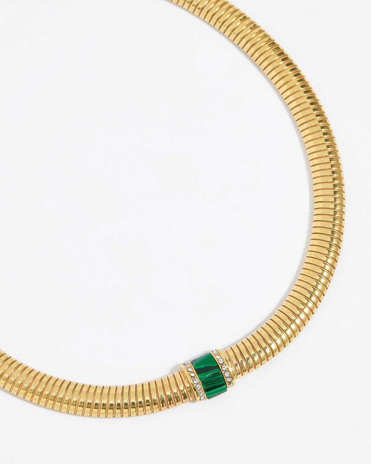 Gold chunky necklace with a green malachite gemstone embellished with clear crystals on a white background