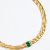Gold chunky necklace with a green malachite gemstone embellished with clear crystals on a white background