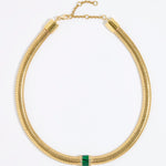 Gold chunky necklace with a central green malachite gemstone embellished with clear crystals on a white background