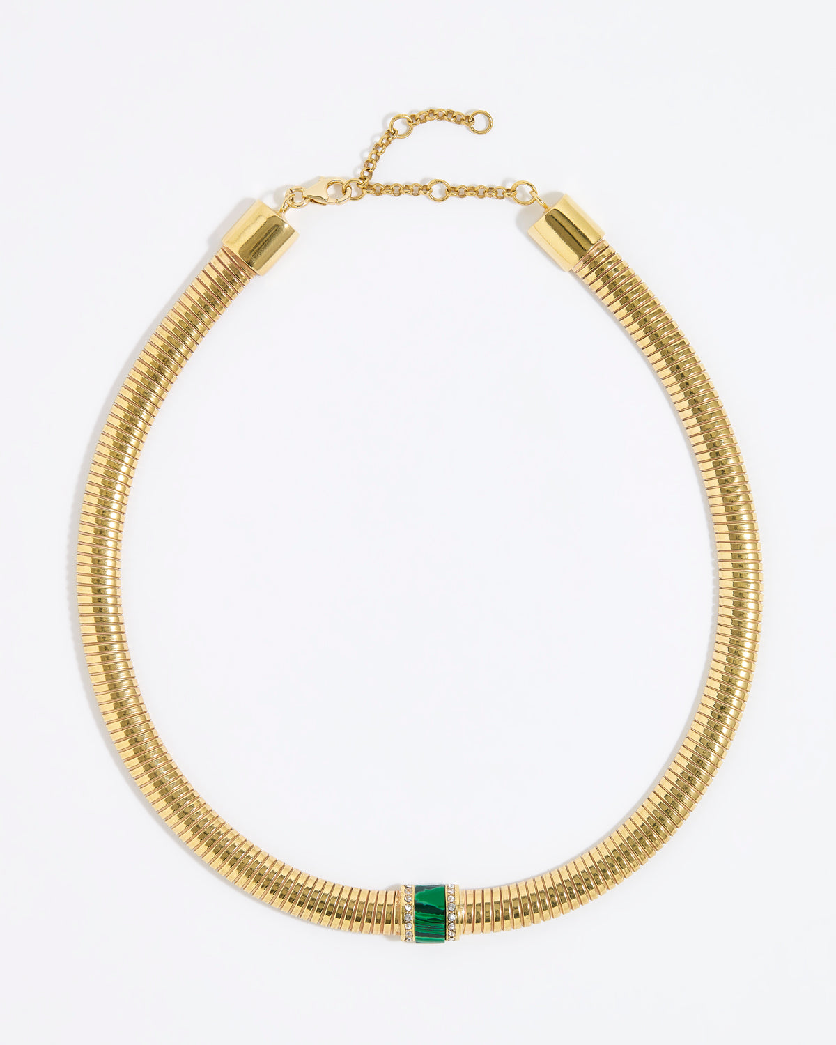 Gold chunky necklace with a central green malachite gemstone embellished with clear crystals on a white background