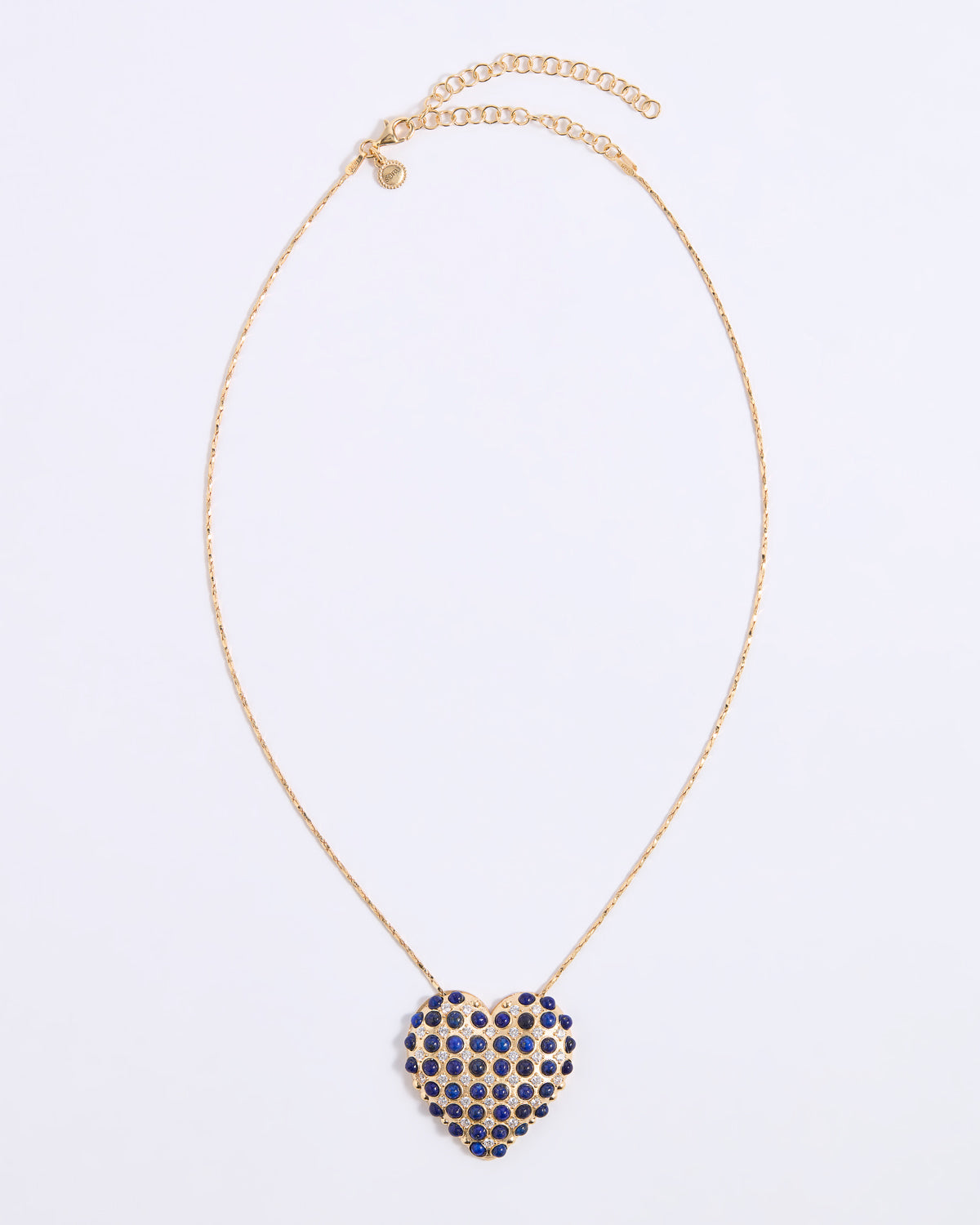 A gold chain necklace with a heart-shaped pendant covered in small dark blue lapis stones and clear sparkling crystals, displayed on a white background.