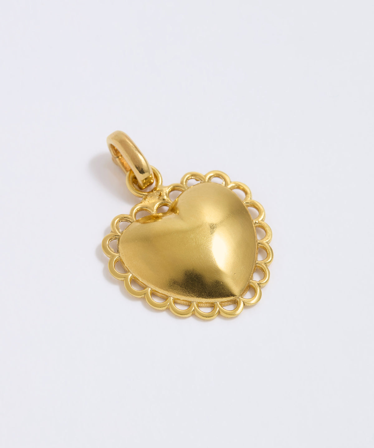 Gold heart-shaped pendant on a light gray background
