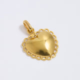 Gold heart-shaped pendant on a light gray background