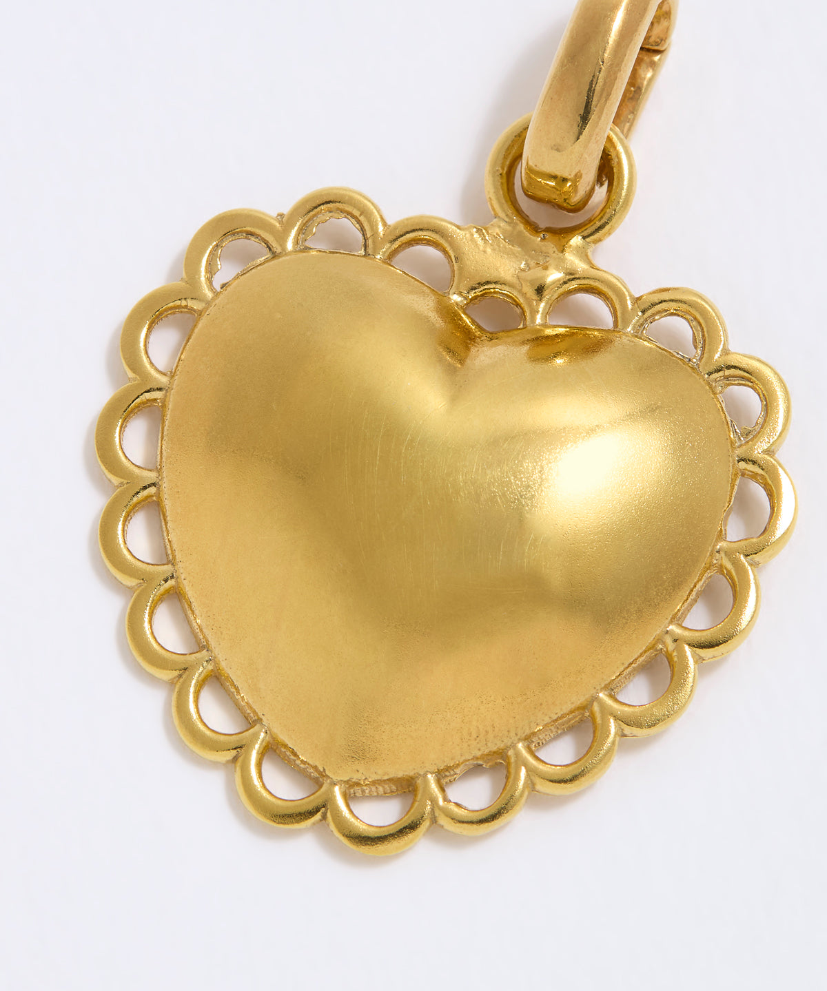 Gold heart-shaped pendant on a white background