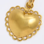 Gold heart-shaped pendant on a white background