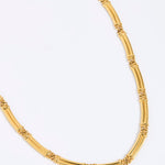 Gold chunky link necklace on a white background link 