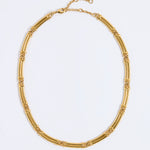 Gold chunky link necklace on a light gray background