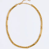 Gold chunky link necklace on a light gray background