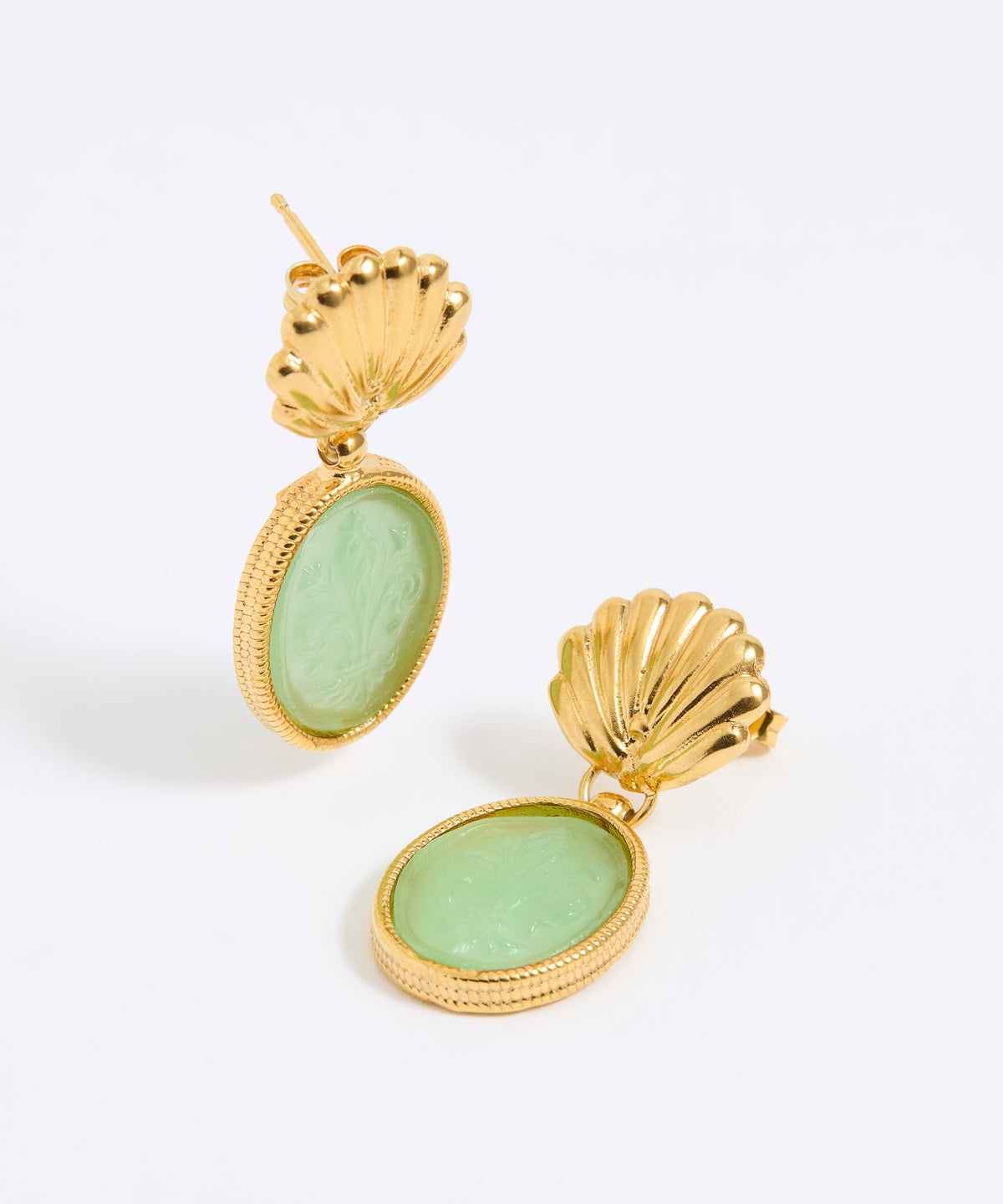 Gold shell earrings with green stones on a white background