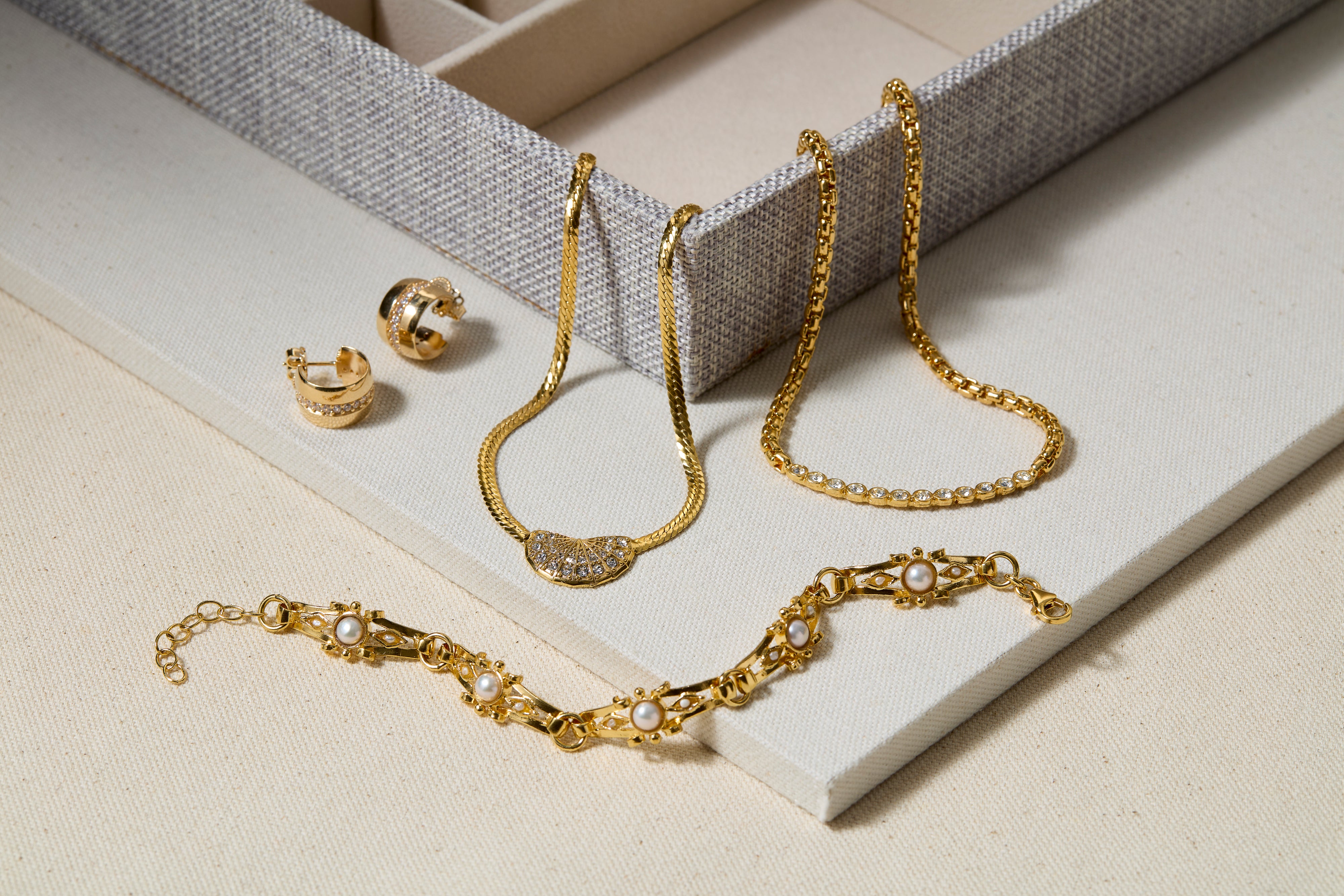 Storage box with jewellery placed around it.