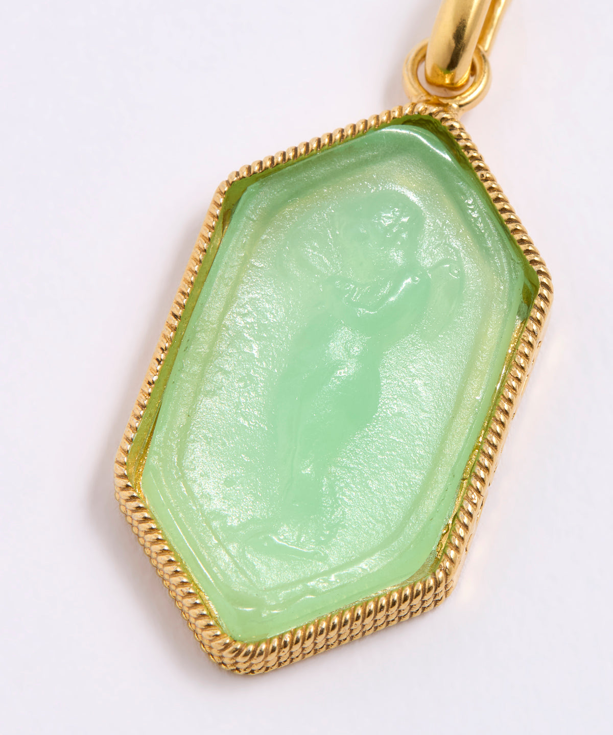 Green stone pendant with gold frame on white background